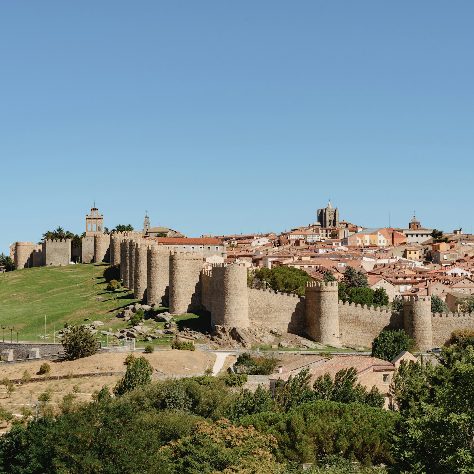 Medieval city walls and towers surrounding the old town of Avila, Spain